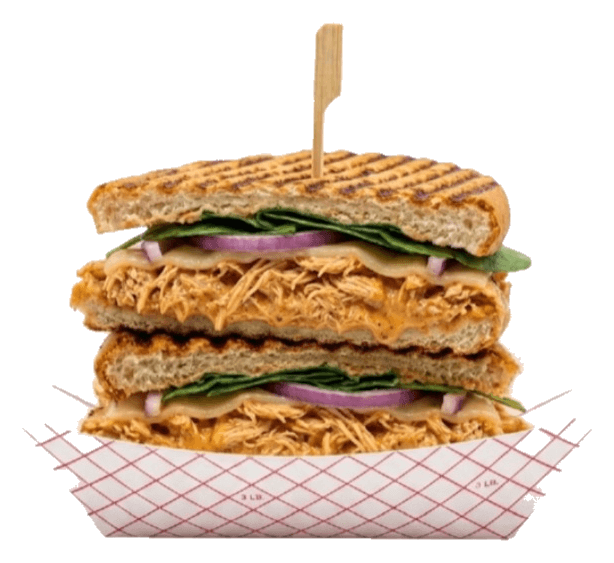 Un panini de Palé a la plancha, cortado a la mitad y apilado en una bandeja de papel